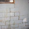 A cracked foundation wall near a window in a Verdi home