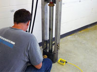 Driving foundation piers into the floor in Yerington.