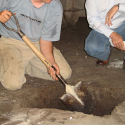 Digging a hole for the engineered fill used in a crawl space support system installation in Gardnerville