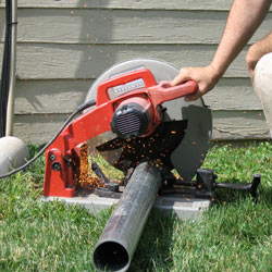 Cutting the support beam for a crawl space jack post outside a Fernley home.