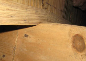 A failing girder showing signs of compression damage in a Nevada home