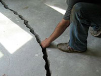 a severely damaged cracked concrete slab floor in Wellington