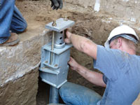Foundation repair contractors installing the foundation bracket in Truckee.