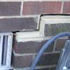A closeup of a failed tuckpointing job where the brick cracked on a Tahoe Vista home.