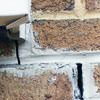 Failed crack repair showing old tuckpointing that cracked on a Truckee home.
