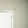 A long drywall crack beginning at the corner of a doorway in a Wellington home.