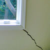A long, diagonal crack that begins at a window corner of a Stateline home