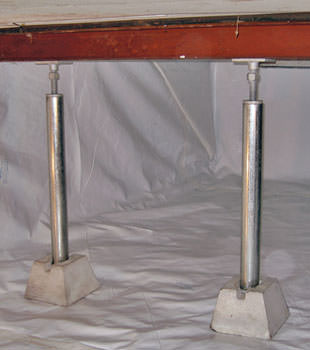 Crawl space jack posts installed in conjunction with a crawl space vapor barrier in Genoa
