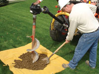 Auguring a hole in the earth for a foundation wall repair system in Fernley
