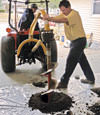 Digging a hole in the garage floor to make room for a wall anchor installation in Doyle, Nevada