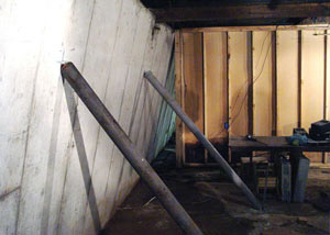 A severely tilting foundation wall propped up by steel beams in Tahoe Vista.