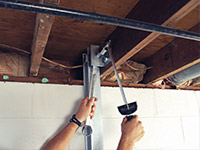 Straightening a foundation wall with the PowerBrace™ i-beam system in a Dayton home.