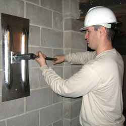 installing a wall anchor to repair an bowing foundation wall in Dayton