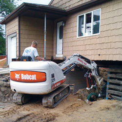 Excavating to expose the foundation walls and footings for a replacement job in Minden